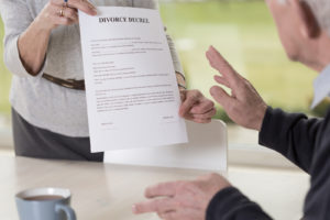 Female Hands Holding Divorce Paper